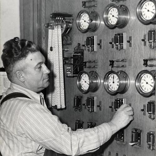 [Joseph Eagan working at the control board of the Ferry Building clock]