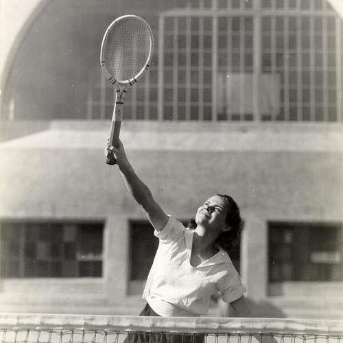 [Young woman playing tennis at Presidio Junior High School]