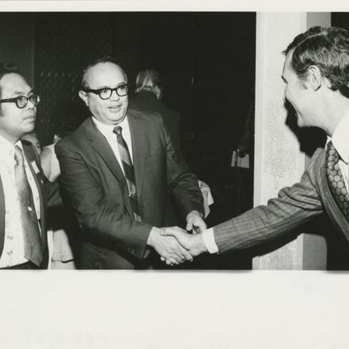 [George Moscone meeting Dr. Amancio Ergina and T.J. San Felipe]