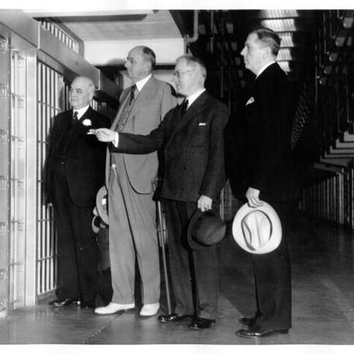 [Mayor Angelo Rossi, U. S. Attorney General Homer S. Cummings, Warden James A. Johnston and San Francisco Police Chief Quinn on a tour of Alcatraz Prison]