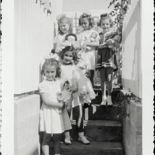 [Girls with dolls in a backyard on 31st Avenue]