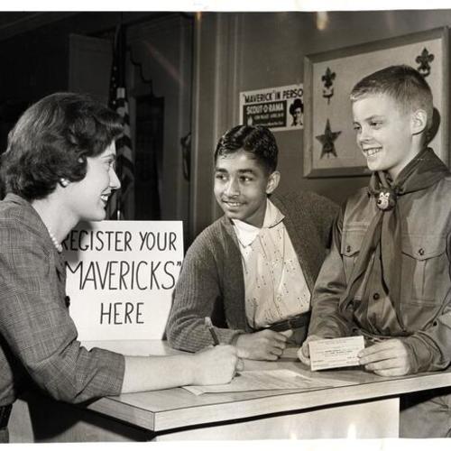 [Marlene Adams giving barbecue tickets to 'Maverick' Som Raj Bhalla and Boy Scout Bill Conklin for the 1958 Scout-O-Rama at the Cow Palace]