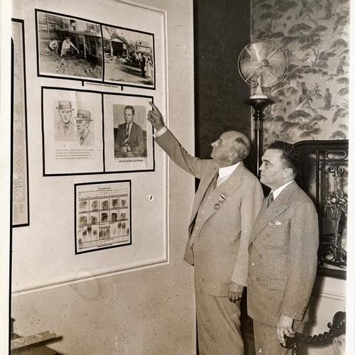 [Attorney General Homer S. Cummings and J. Edgar Hoover, Chief of the Bureau of Investigation, Department of Justice looking at the Lindbergh kidnaping display]
