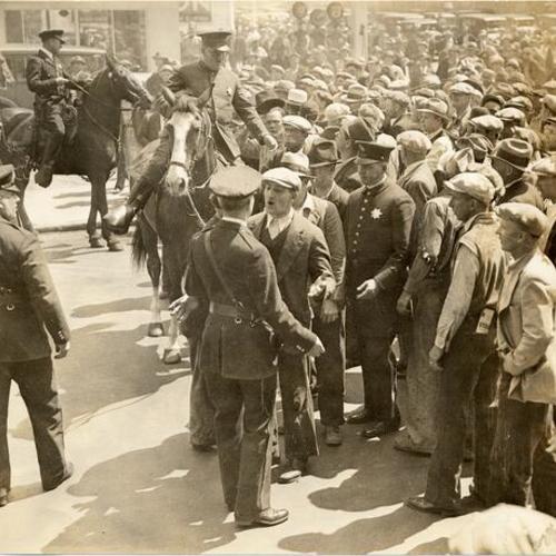 [Police officers controlling crowd during Longshoremen's Strike]