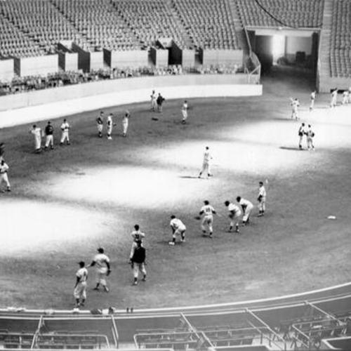 [San Francisco Seals practicing in the Cow Palace on a rainy day]