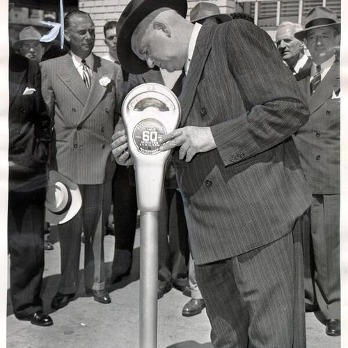 [Mayor Roger D. Lapham testing the first parking meter in San Francisco]