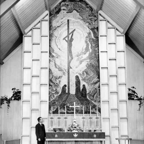 [Rev. William Baker standing next to a mosaic inside the Grace Evangelical Lutheran Church]