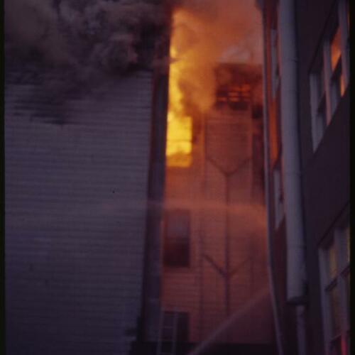 [Fire and smoke come out of top floor in building]