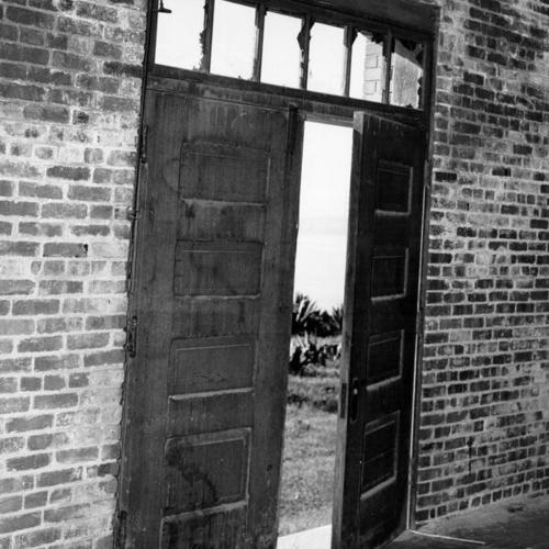 [Paneled door in an old storage building on the waterfront]