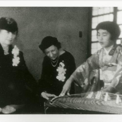[Helen Keller and her aide, Ms. Thomson, with Sumi playing the koto for a reception before Helen Keller went to Japan]