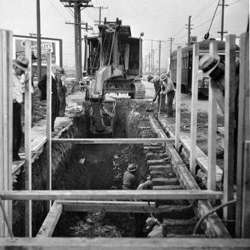 [Laborers working on the excavation for Third Street sewer near the Isthmus Creek Bridge]