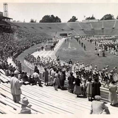 [Uniformed children marching in front of a crowd at Kezar Stadium]