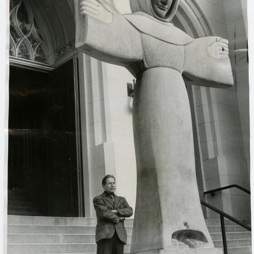[Sculptor Beniamino Bufano standing next to his statue of Saint Francis of Assisi at the entrance of the St. Francis of Assisi Church]