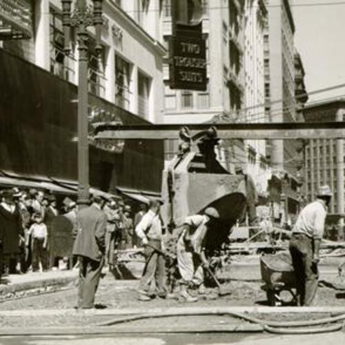 [Spectators watching work crew mixing cement at Post  and Kearny streets]