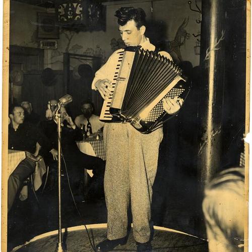 [Unidentified man playing the accordion restaurant in North Beach]