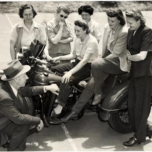 [Rita Bernell, Mary M. O'Mally, Vera C. Wendt, Elizabeth M. Rickey, Amy Sliger and (seated) Florence M. Moodie with Sergeant Fred Flynn, instructor at the Police Academy]