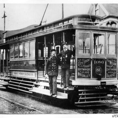[Two employees of the Market Street Railway Company posing with a streetcar]