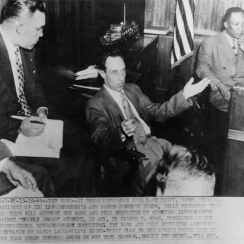 [Harry Bridges talks to reporters at press conference ]