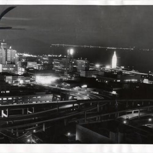 [View of Coit Tower, the Ferry Building and Embarcadero Freeway at night]