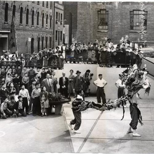 [Chinese dragon dancing at Commodore Stockton School at Clay and Powell streets]
