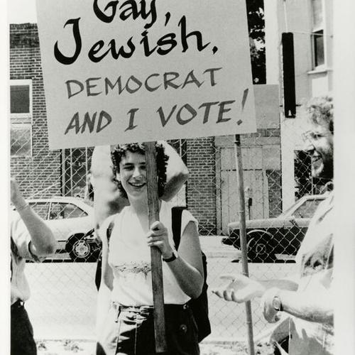 [A woman holding a sign during the Democratic Convention in 1984]