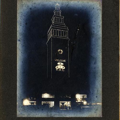 [View of Ferry Building at night with decorative lighting]