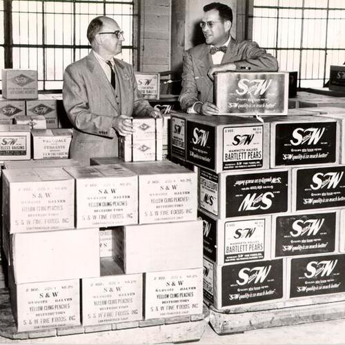 [James L. Roney and Joseph Blumlein, of S & W Fine Foods, Inc., inspecting a shipment of goods at the San Francisco waterfront]