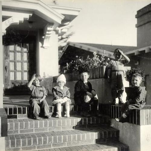 [Children sitting on the front steps of 682 Miramar Avenue]