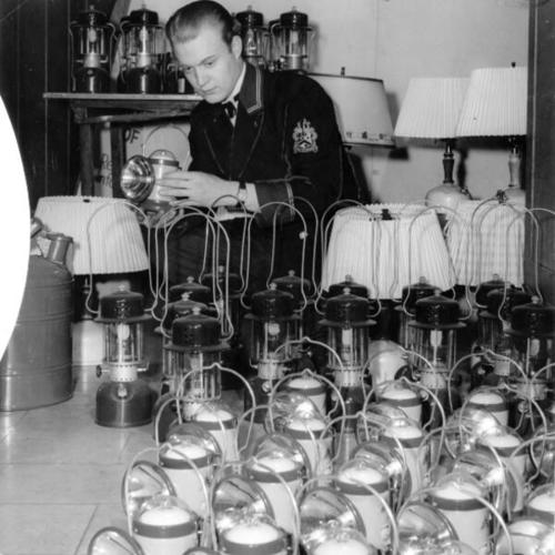 [Employee Hugh Hollan of the St. Francis Hotel in a room full of gasoline and battery powered lamps]