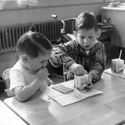 [Two children having a snack at Gough School for the Deaf, 1945 Washington Street]