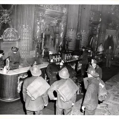 [Firemen in snack bar of Fox Theater after fire]
