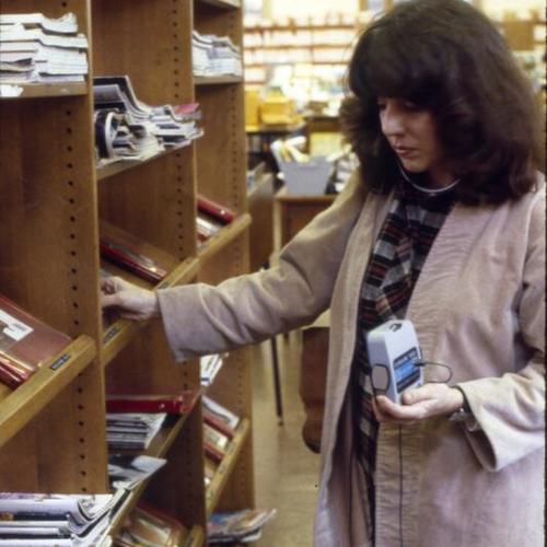 [Woman browses magazines in the Presidio branch]