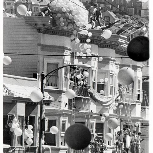 [Balloons being released from roofs at Castro Street Fair in 1976]