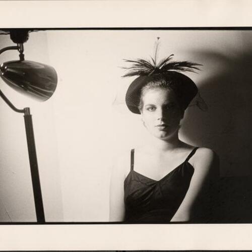 Penelope Houston posing in hat with lamp lighting at apartment in North Beach