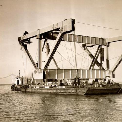 [View of workmen hanging steel for constructing San Francisco-Oakland Bay Bridge]