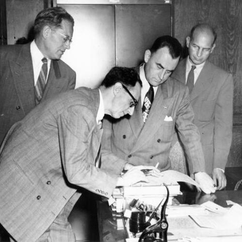 [Harry Bridges signing release after surrendering to federal authorities on charges of perjury and conspiracy]