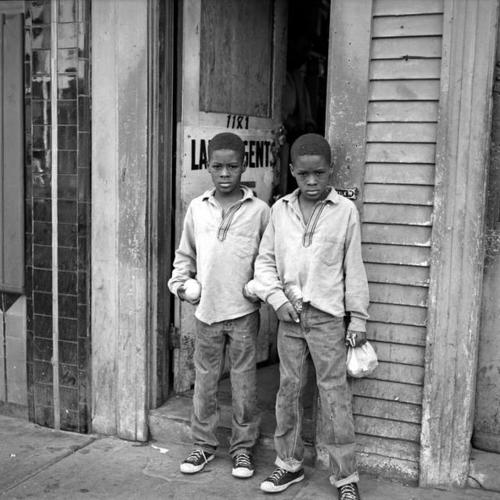 Twin boys standing in front of door