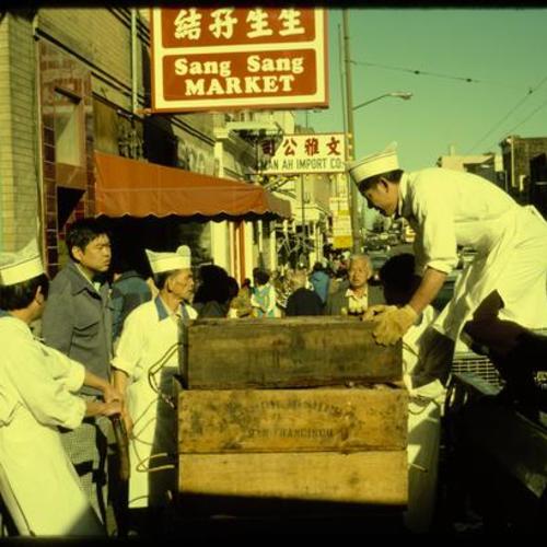 Chinatown market receiving fish delivery on Stockton Street