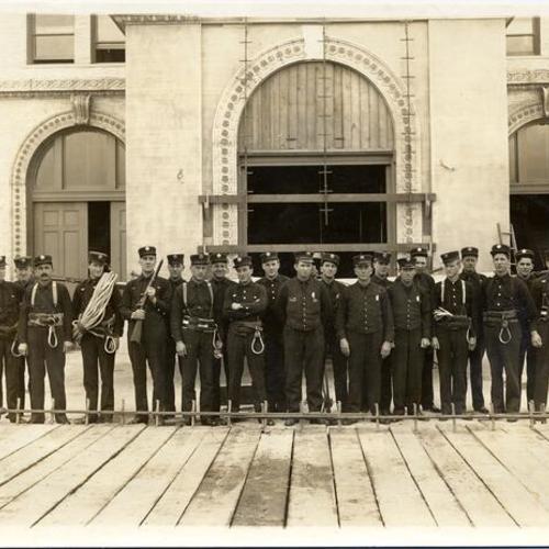 [Fire Department personnel at a fire equipment exposition near the Panama-Pacific International Exposition]