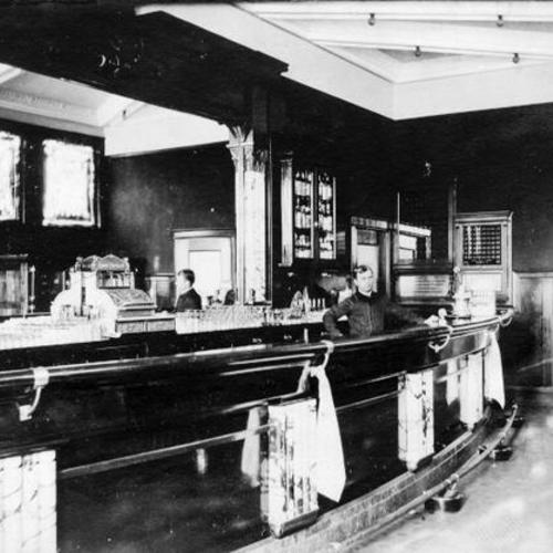 [C. E. Morgan behind the bar at the Hotel Cairns at 36th Avenue and Fulton Street]
