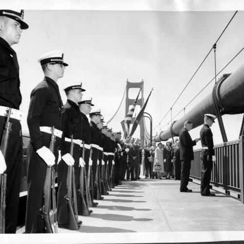 [Matthew Connolly delivering memorial prayer at a ceremony on the center span of Golden Gate Bridge]