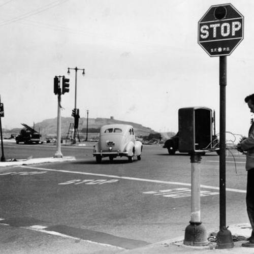 [Jack Pressy installing a control box for three-way traffic lights at the intersection of O'Shaughnessy Boulevard, Woodside Avenue and Portola Drive]