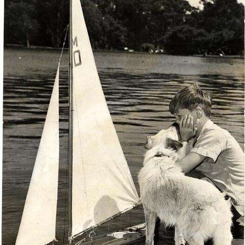 [Jimmy Fox with his dog and a model yacht on Spreckels Lake in Golden Gate Park]