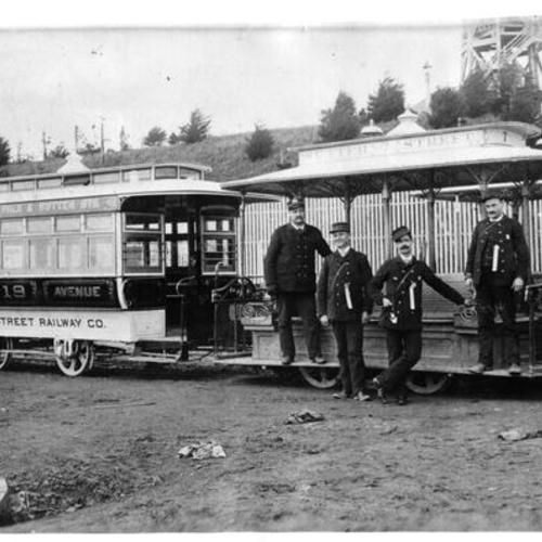 [Sutter Street Railway Company employees posing in front of cable cars]