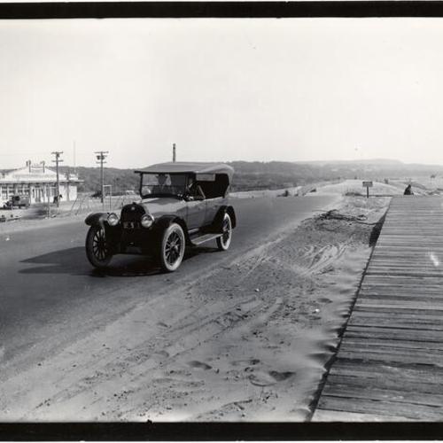 [Two men sitting in a car at Great Highway and Sloat Boulevard]