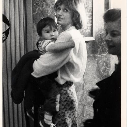[Mary Ann White (Mrs. Dan White) and son Charlie outside of courtroom of Dan White trial]