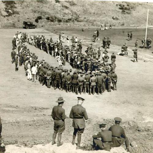 [Soldiers gathered at an athletic field in the Presidio]