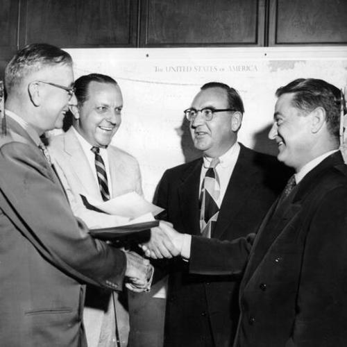 [Attorney General Edmund G. "Pat" Brown (third from left) at a tribute for two members of the State Bureau of Criminal Identification and Investigation]