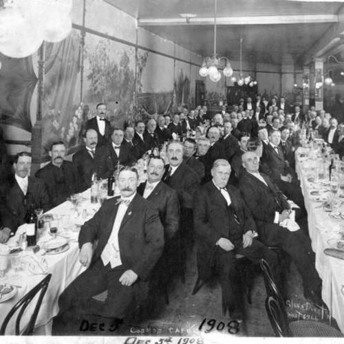 [Large group of men dining at Cosmos Cafe]