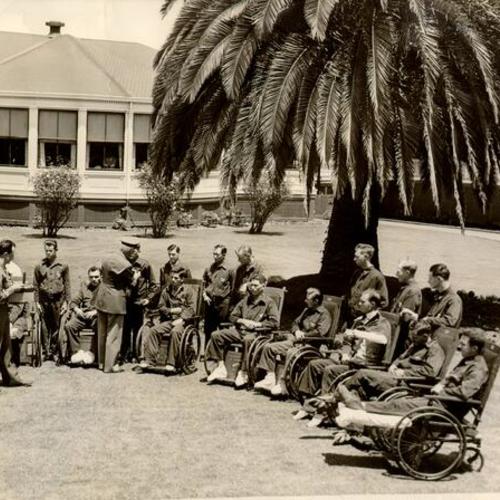 [Wounded veterans receiving Purple Heart medals on a lawn outside Letterman General Hospital]